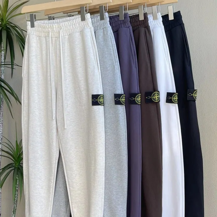 A seller photo of plain fleece sweatpants hanging in grey, navy, black and white