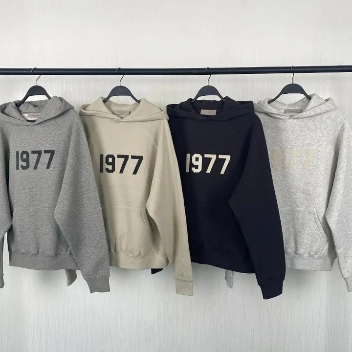 Four people wearing matching hoodies and sweatpants in neutral colours, photographed as a seller lookbook