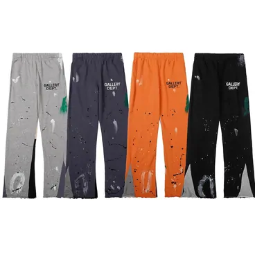 Paint-splatter joggers hanging in grey, navy, orange and black