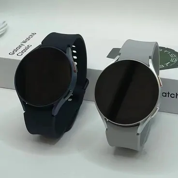 Two round smartwatches in black and silver